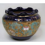 An early 20th century Royal Doulton blue glazed stoneware jardiniere, having a central band of