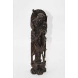 A Japanese carved hardwood figure of a man, having white metal inlaid decoration, 37cm high