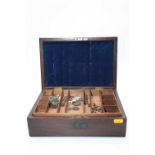 A 19th century mahogany box, containing a collection of miscellaneous items to include coins