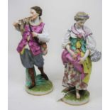 A pair of 20th century German porcelain figures, each shown in 18th century dress, each 33cm