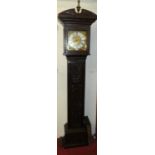 A floral relief carved oak longcase clock, having a silvered and gilt brass square dial (with single