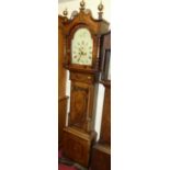 An early 19th century oak and mahogany long case clock, having a painted arch dial with subsidiary