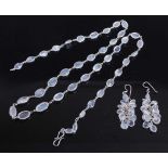 A white metal moonstone multi-stone necklace with matching earrings, the necklace comprising forty