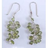 A pair of white metal peridot multi-stone earrings, each with 15 round faceted peridots in bezel