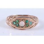 An Edwardian 9ct yellow gold, opal and emerald dress ring, featuring a centre round opal cabochon