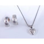 A white gold diamond pendant and earring set, the pendant comprising a satin finish heart set with