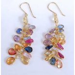 A pair of yellow metal multi-sapphire drop earrings, each featuring sixteen oval faceted vari-