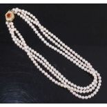 A three-row cultured pearl choker, having 77, 74 and 71 4.6 to 4.85mm pearls strung plain to ta 14ct