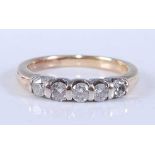 A yellow and white metal diamond five stone half hoop eternity ring, comprising five round brilliant