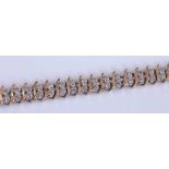 A 9ct yellow and white gold two-row diamond line bracelet, featuring 53 pairs of single cut diamonds