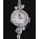 A 9ct white gold lady's Girard Peregaux diamond set manual wind cocktail watch, having a round