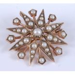 A 9ct yellow gold pearl eight-ray star brooch, featuring thirty-three 1.5 to 3.9mm seed pearls in