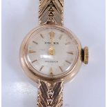 A 9ct yellow gold lady's Rolex Precision manual wind wristwatch, having round cream baton dial and