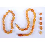 Two strands of butterscotch amber beads, one with 21 strung plain to a white metal bolt ring