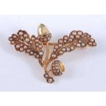 A yellow metal acorn and oak leaf brooch, set with sixty-six 1.2 to 2mm seed pearls (2 deficient),