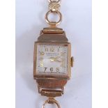 A 9ct yellow gold Winegartens ladies manual wind wristwatch, having a square cream Arabic dial and