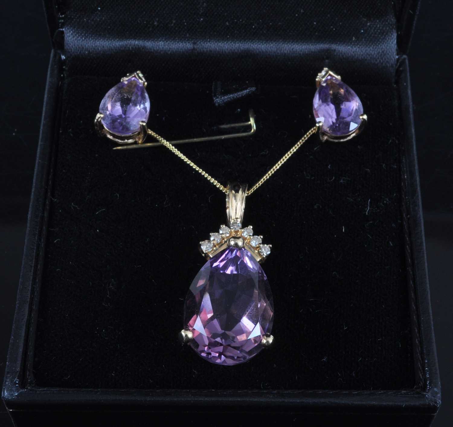 A 14ct yellow gold, amethyst and diamond pendant and earring set, the pendant featuring a pear cut