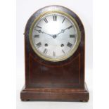 A late 19th century mahogany and boxwood strung cased domed top bracket clock having a convex