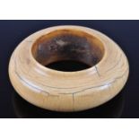 An early 20th century African ivory bangle, of squat circular form with raised lip, probably Luba