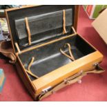 A vintage tan leather travel suitcase with cloth cover, having a concealed seven-piece silver and