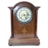 An Edwardian mahogany and satinwood inlaid cased dome topped mantel clock, the circular enamelled