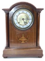 An Edwardian mahogany and satinwood inlaid cased dome topped mantel clock, the circular enamelled