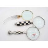A collection of three modern table magnifying glasses