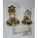 A 20th century lacquered brass anniversary clock under glass dome, height 24cm, together with one