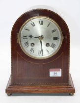 An Edwardian mahogany and chequer strung cased mantel clock having a silvered dial with Roman