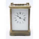 A 20th century lacquered brass cased carriage clock having an enamel dial with inner Roman