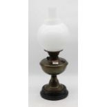 An early 20th century brass pedestal oil lamp, having opalescent globular shade, h.47cm