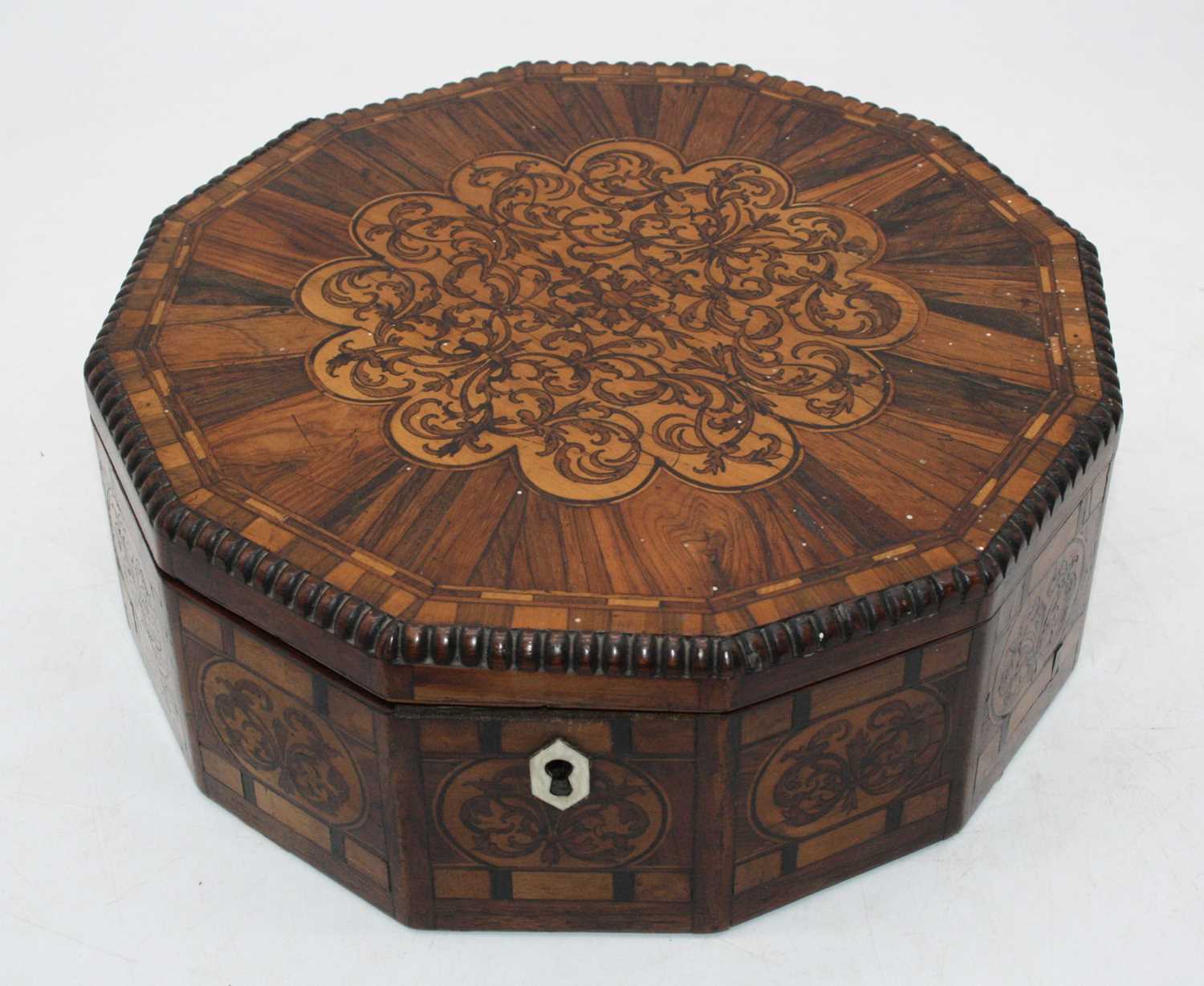 A late Regency specimen wood workbox of dodecagon shape the hinged lid inlaid with rosewood,