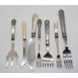 A small collection of loose flatware, to include fish fork with silver clad handle, mother of
