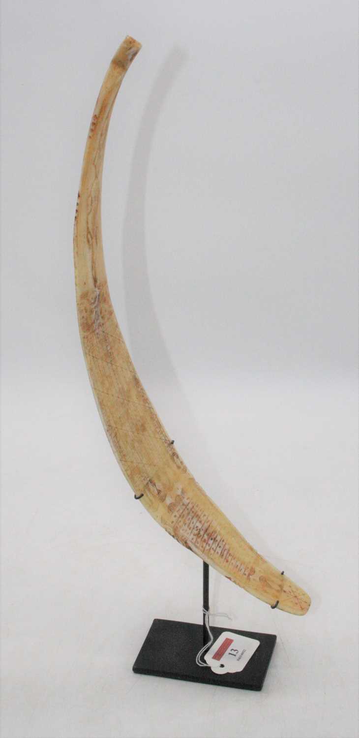 An animal bone divination wand/calendar, the tip carved with two facing reptiles and the opposing