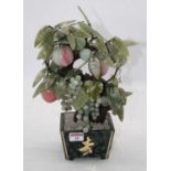 A 20th century polished hardstone table ornament in the form of a vase of fruit, height 32cm