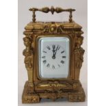 A 20th century gilt painted carriage clock, the enamel dial showing Roman numerals, height 15cm