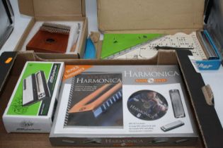 A boxed Japanese FMT Zippy Zither, boxed, together with a 17 key kalimba, and a Simply Harmonica