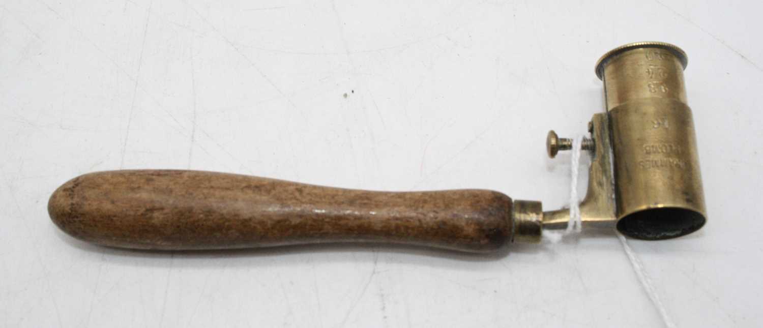 An early 20th century shot/powder measure having an adjustable brass nozzle on turned beech