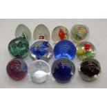 A collection of 12 various glass paperweights