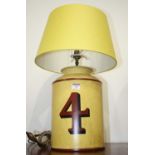 A modern Toleware type table lamp from Woolpit Interiors, in the form of a yellow canister painted