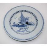 An 18th century English Delft blue & white charger, the centre underglazed decorated with trees