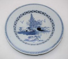 An 18th century English Delft blue & white charger, the centre underglazed decorated with trees