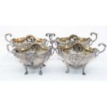 A set of four late Victorian silver open salts, each of boat shape with pierced and C-scrolling