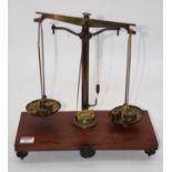A set of Victorian brass beam scales, on mahogany plinth, bearing a plaque for W&J George Ltd, FE