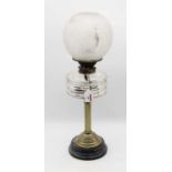 An early 20th century brass pedestal oil lamp, having opalescent globular shade and clear glass