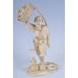 A Japanese Meiji period (1868-1912) ivory okimono, carved as a male fruit seller standing upon one