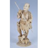 A Japanese Meiji period (1868-1912) ivory okimono, carved as a spear fisherman in standing pose with