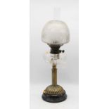 A late Victorian oil lamp, having etched opalescent shade above a clear glass font, on a fluted
