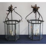 A pair of brass-framed and glass ceiling light fittings, each of hexagonal form, h.65cmGlass is
