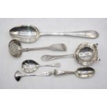 An 18th century silver serving spoon; together with a Victorian Scottish silver sifting spoon;